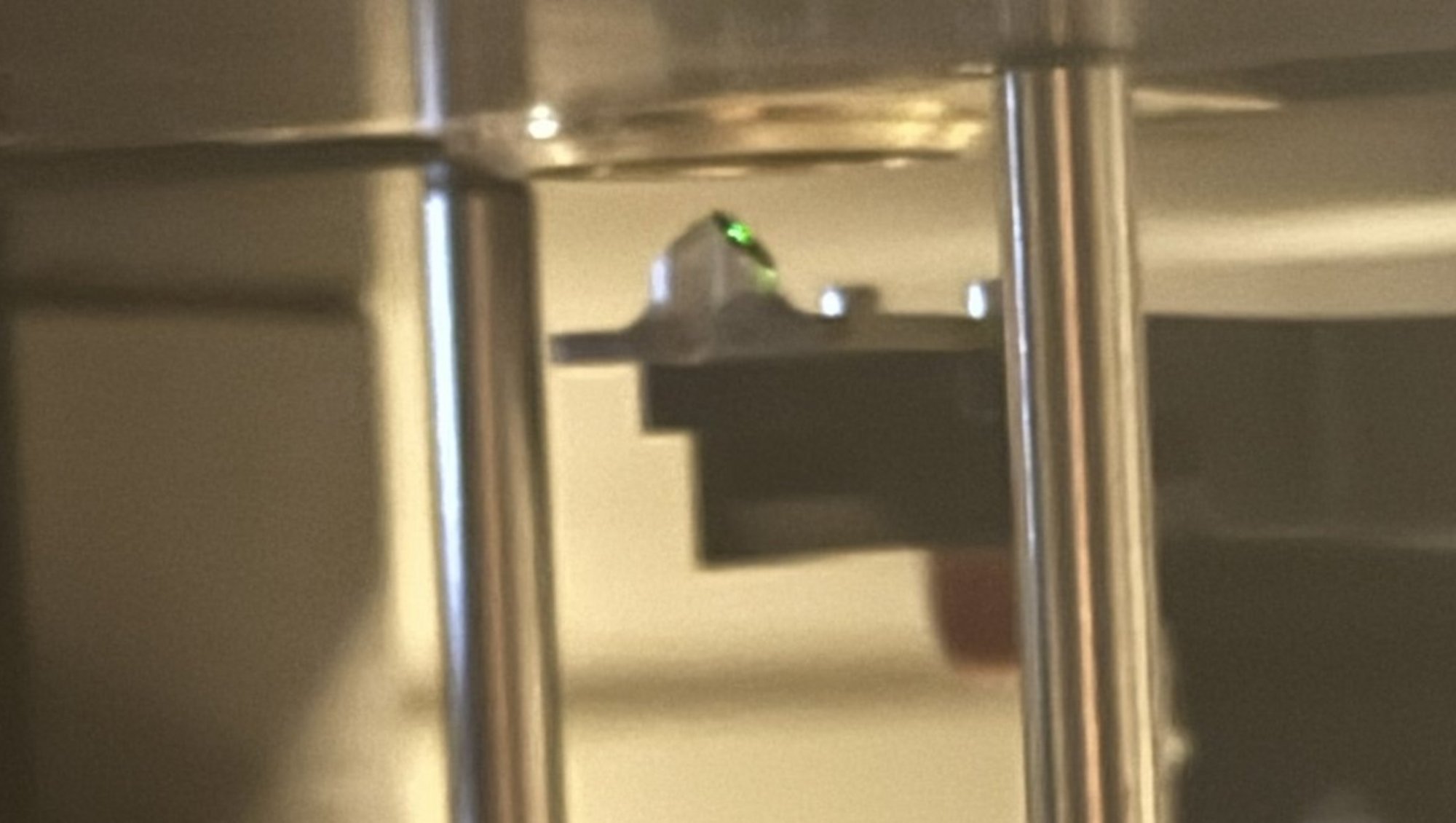 The green laser hitting the entrance mirror 